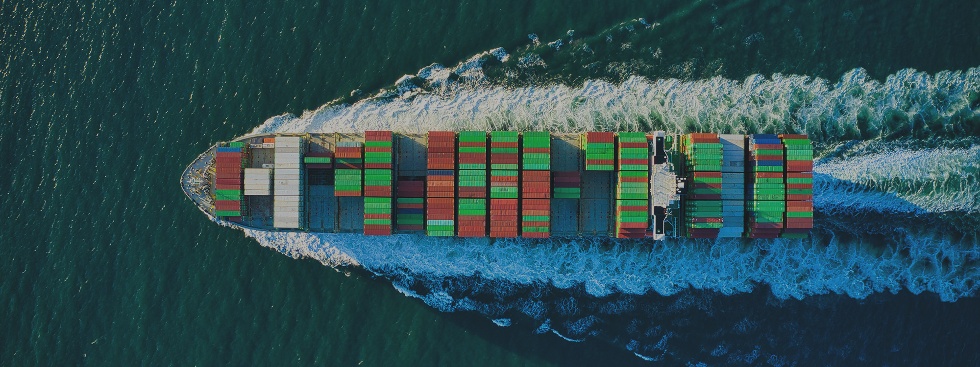 Shipping containers and cranes at a global cargo port